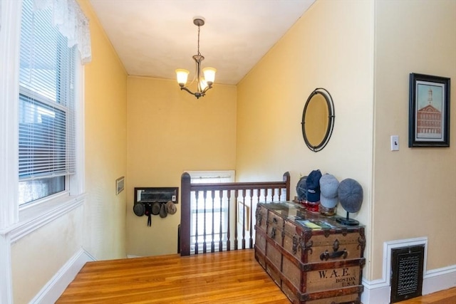18 Dighton St Unit 18, Boston, MA 02135 - stairs with a chandelier, baseboards, and wood finished floors