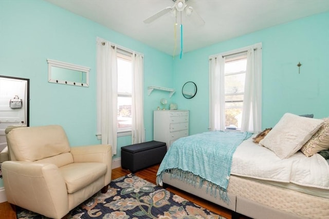 18 Dighton St Unit 18, Boston, MA 02135 - bedroom with wood finished floors, multiple windows, ceiling fan, and baseboards