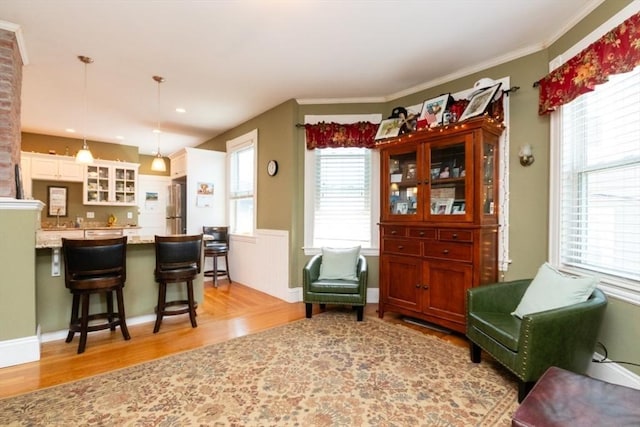 18 Dighton St Unit 18, Boston, MA 02135 - living area featuring light wood finished floors, a wainscoted wall, crown molding, and recessed lighting