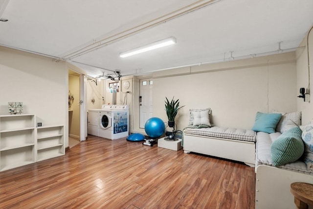 workout room featuring wood finished floors and washer and clothes dryer