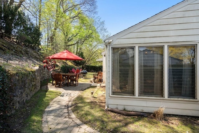 view of home's exterior featuring outdoor dining area and a patio area