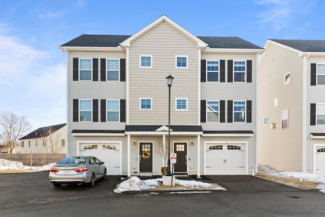 townhome / multi-family property featuring a garage and driveway