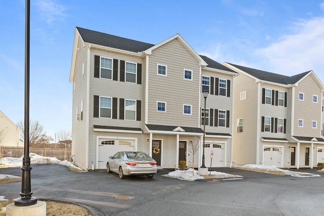 townhome / multi-family property with driveway and an attached garage