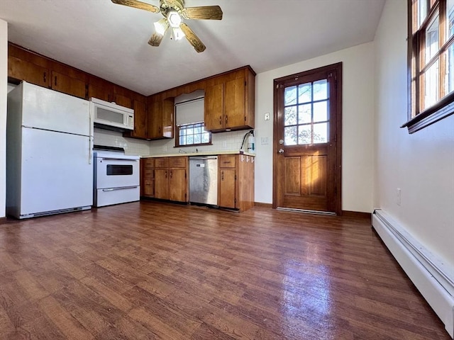 kitchen featuring white appliances, dark hardwood / wood-style floors, decorative backsplash, baseboard heating, and ceiling fan