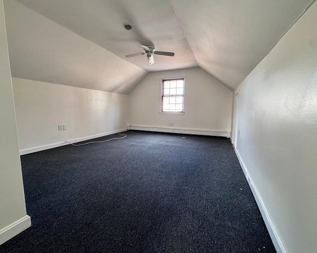 bonus room featuring lofted ceiling, dark carpet, baseboard heating, and ceiling fan