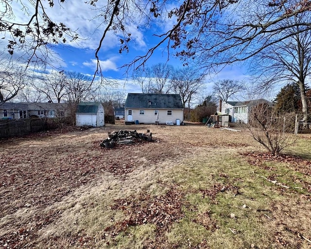 view of yard with a playground and a shed