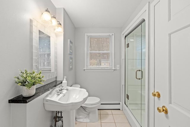 bathroom with tile patterned flooring, toilet, a baseboard heating unit, a sink, and a shower stall