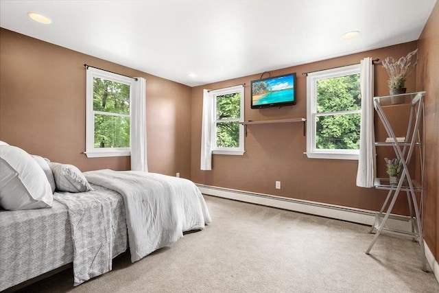 carpeted bedroom with a baseboard radiator