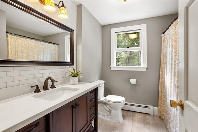 full bathroom featuring toilet, baseboard heating, backsplash, and vanity