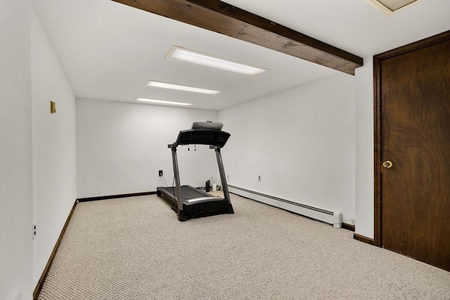 exercise room with a baseboard heating unit, carpet floors, and baseboards