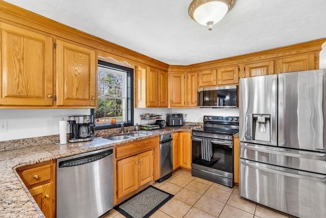 13 Old Gardner Rd, Westminster, MA 01473 - kitchen with light tile patterned flooring, appliances with stainless steel finishes, brown cabinetry, and a sink