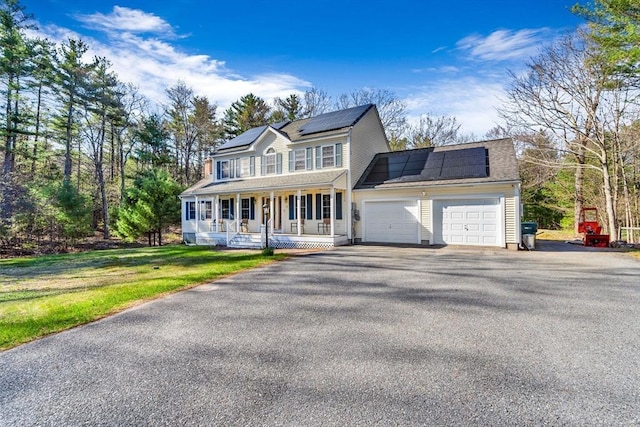 13 Old Gardner Rd, Westminster, MA 01473 - view of front of house featuring a front lawn, an attached garage, a porch, driveway, and solar panels