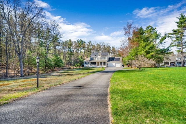 13 Old Gardner Rd, Westminster, MA 01473 - view of front facade featuring aphalt driveway, roof mounted solar panels, and a front lawn