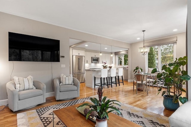4 Greenfield Ln Unit 4, Concord, MA 01742 - living room featuring light wood-type flooring, ornamental molding, baseboards, recessed lighting, and a chandelier