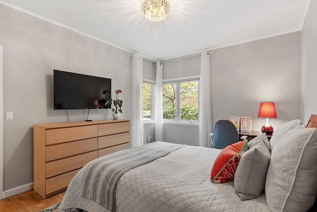 4 Greenfield Ln Unit 4, Concord, MA 01742 - bedroom with light wood-style floors, crown molding, baseboards, and a chandelier