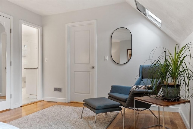 4 Greenfield Ln Unit 4, Concord, MA 01742 - sitting room featuring wood finished floors, lofted ceiling, baseboards, and a skylight
