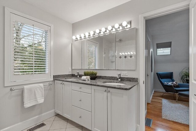 4 Greenfield Ln Unit 4, Concord, MA 01742 - full bathroom with double vanity, baseboards, and wood finished floors