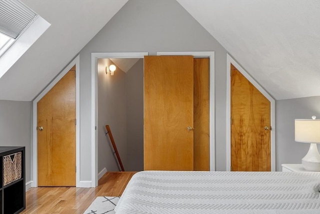 4 Greenfield Ln Unit 4, Concord, MA 01742 - bedroom with vaulted ceiling, wood finished floors, and baseboards