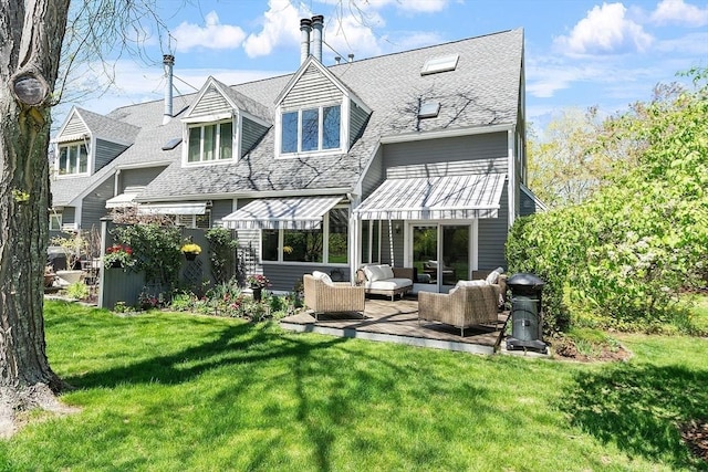 4 Greenfield Ln Unit 4, Concord, MA 01742 - back of property with an outdoor hangout area, a lawn, and a shingled roof