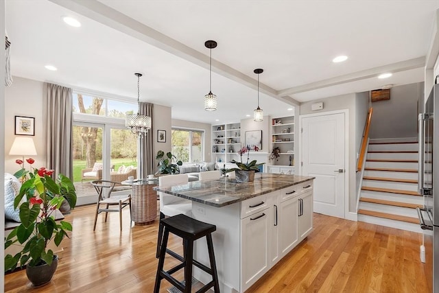 4 Greenfield Ln Unit 4, Concord, MA 01742 - kitchen featuring white cabinetry, dark stone countertops, open floor plan, hanging light fixtures, and recessed lighting