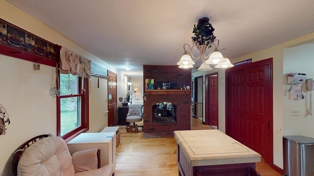 330 Arbor St, Lunenburg, MA 01462 - living room with light wood-type flooring, a fireplace, and a chandelier