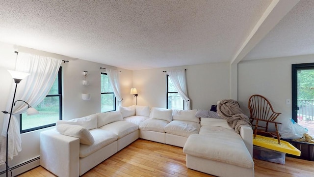 330 Arbor St, Lunenburg, MA 01462 - living area with baseboard heating, a textured ceiling, healthy amount of natural light, and light wood-type flooring