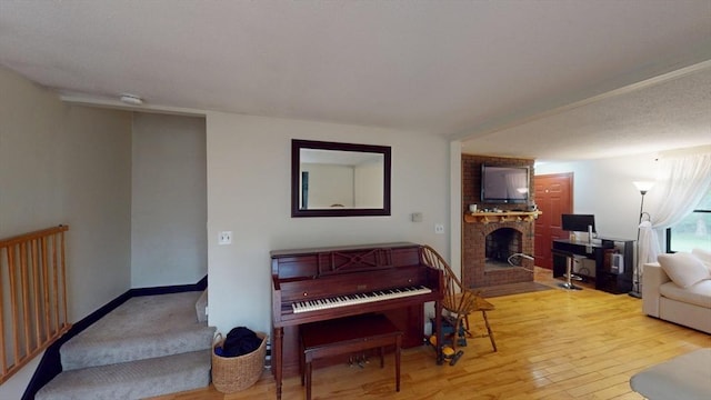 330 Arbor St, Lunenburg, MA 01462 - living room featuring hardwood / wood-style flooring and a brick fireplace