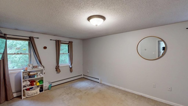 330 Arbor St, Lunenburg, MA 01462 - carpeted empty room featuring a textured ceiling and baseboard heating