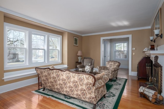 living area with a wealth of natural light, light wood-type flooring, and crown molding