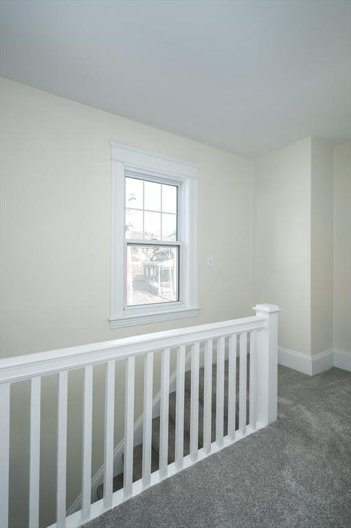 empty room with baseboards and carpet floors