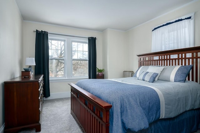 bedroom with ornamental molding, baseboards, and carpet floors