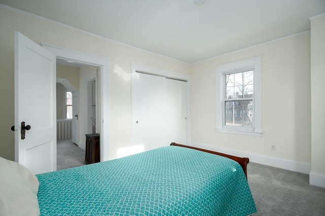 unfurnished bedroom with multiple windows, carpet, a closet, and baseboards