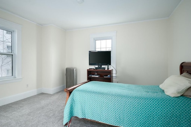 bedroom featuring baseboards, radiator, crown molding, and carpet