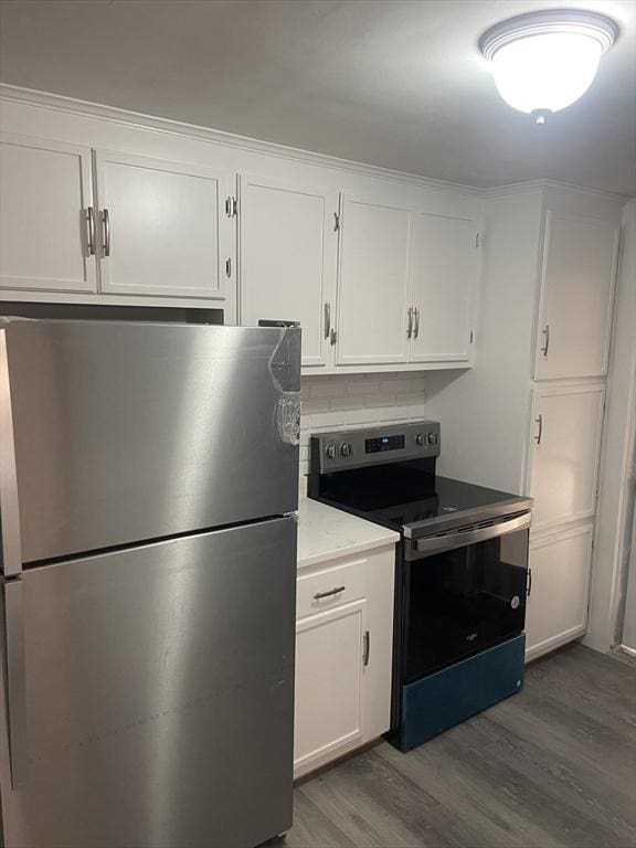 kitchen with white cabinetry, dark wood-type flooring, light countertops, and appliances with stainless steel finishes