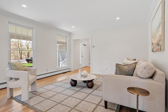 living area featuring light wood-style floors, crown molding, and a baseboard heating unit