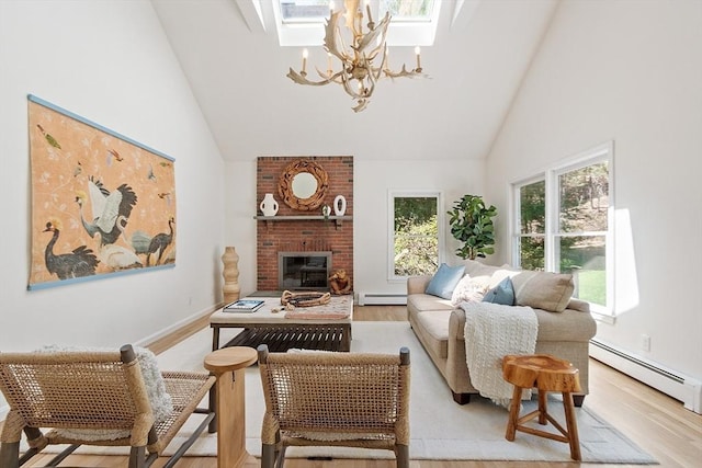 sitting room with a skylight, high vaulted ceiling, a baseboard radiator, an inviting chandelier, and light wood-style flooring