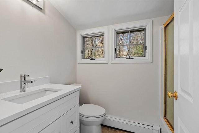 bathroom featuring vanity, toilet, an enclosed shower, tile patterned floors, and a baseboard heating unit