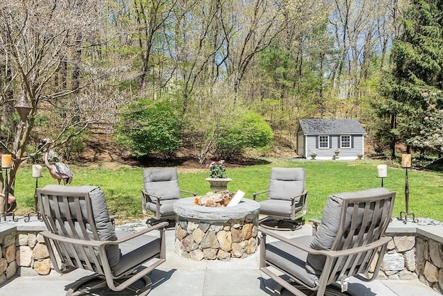 view of patio / terrace with an outdoor structure and a fire pit