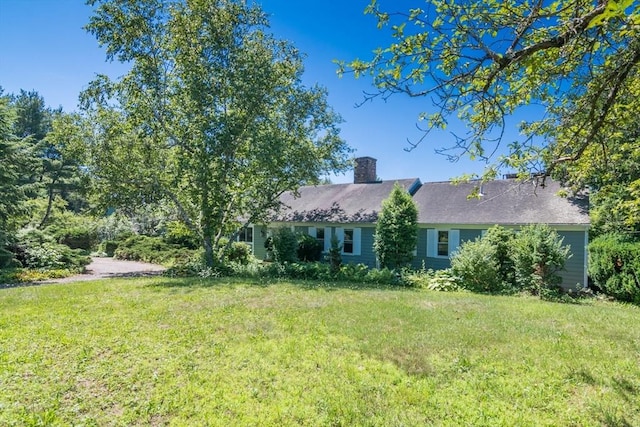 53 Iduna Ln, Amherst, MA 01002 - rear view of property featuring a lawn and a chimney