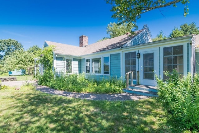 53 Iduna Ln, Amherst, MA 01002 - back of property with a chimney and a lawn