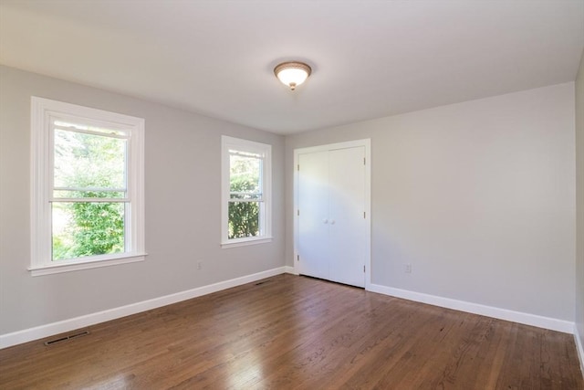 53 Iduna Ln, Amherst, MA 01002 - spare room featuring baseboards and dark wood-type flooring
