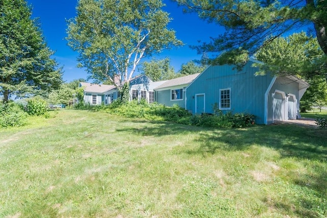 53 Iduna Ln, Amherst, MA 01002 - view of green lawn featuring a garage