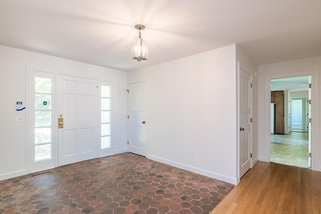 53 Iduna Ln, Amherst, MA 01002 - foyer featuring stone finish floors and a chandelier