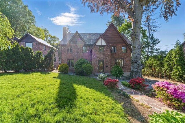 15 Park Ave, Newton, MA 02458 - tudor home featuring a chimney, a front yard, and brick siding