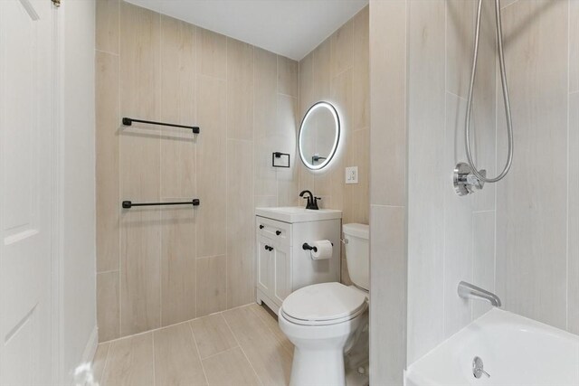 15 Park Ave, Newton, MA 02458 - bathroom with tile walls, toilet, vanity, and bathtub / shower combination