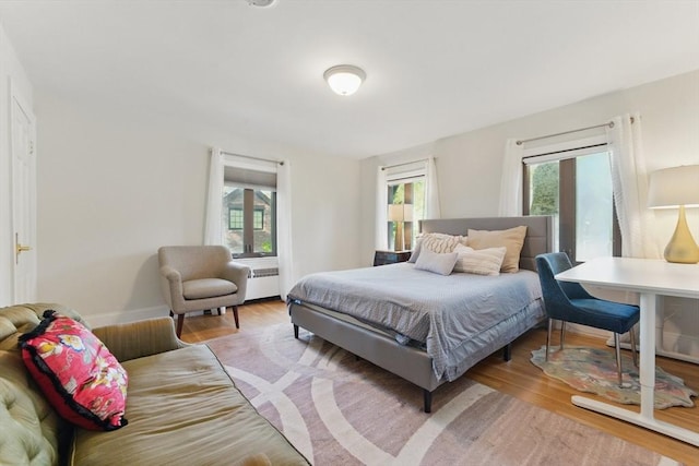 15 Park Ave, Newton, MA 02458 - bedroom with multiple windows, light wood finished floors, and baseboards