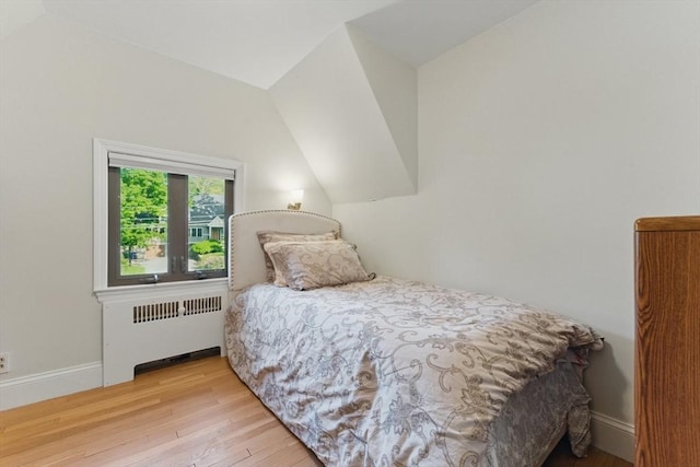 15 Park Ave, Newton, MA 02458 - bedroom with radiator heating unit, wood-type flooring, baseboards, and vaulted ceiling