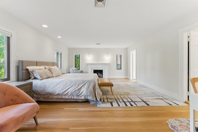 15 Park Ave, Newton, MA 02458 - bedroom featuring wood finished floors, recessed lighting, a fireplace, and baseboards