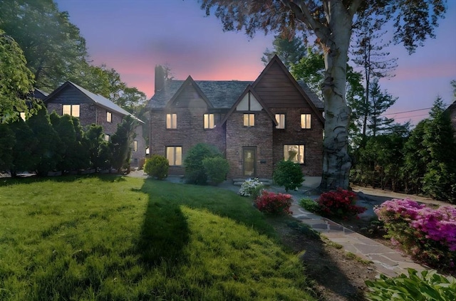 15 Park Ave, Newton, MA 02458 - tudor house featuring a chimney, a lawn, and brick siding