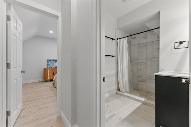 15 Park Ave, Newton, MA 02458 - full bathroom featuring a shower stall, baseboards, toilet, lofted ceiling, and wood finished floors